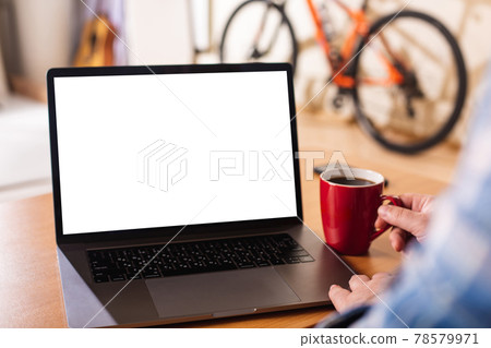 Laptop with blank white screen and male hands on the keyboard. Laptop with blank white screen and male hands on the keyboard. 78579971