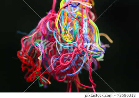 Multicolored tangled threads for needlework on black background Multicolored tangled threads for needlework on black background 78580318