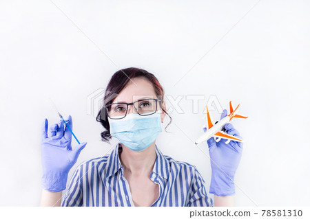 Nurse holding vaccine syringe and airplane model, vaccination against the virus covid-19. vaccination against covid-19 for traveling and vaccine passport Nurse holding vaccine syringe and airplane model, vaccination against the virus covid-19. vaccination against covid-19 for traveling and vaccine passport 78581310