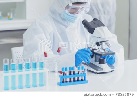 Male Scientist look into Microscope research in science laboratory. Asian scientist looking equipment laboratory chemistry labs. Covid-19 coronavirus biochemistry research experiment vaccine concept Male Scientist look into Microscope research in science laboratory. Asian scientist looking equipment laboratory chemistry labs. Covid-19 coronavirus biochemistry research experiment vaccine concept 78585079