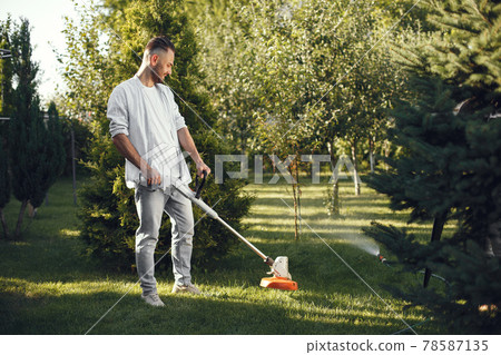 Lawn mower man working on the backyard 78587135