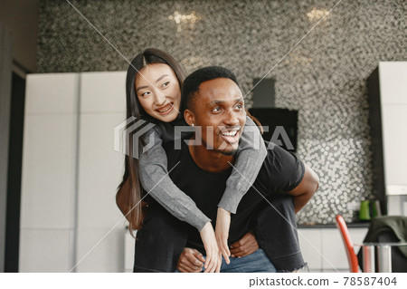 Happy couple have fun in their new apartment Happy couple have fun in their new apartment 78587404