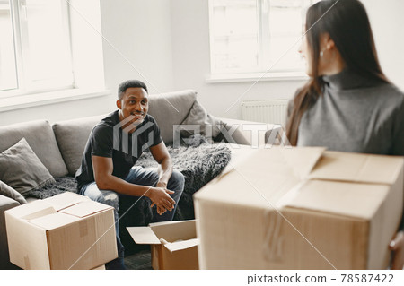 Couple unpacking boxes at their new home 78587422
