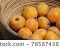Fresh loquat fruit in a wicker basket 78587438