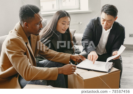 Realtor Explaining Agreement To Couple In New Apartment Realtor Explaining Agreement To Couple In New Apartment 78587456