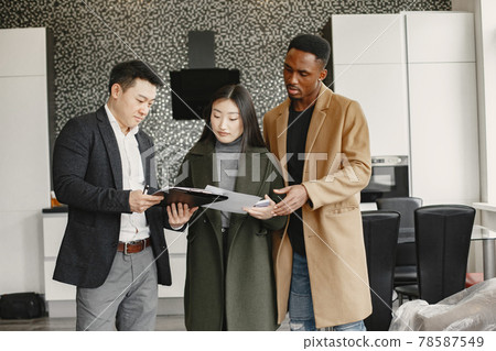 Realtor Explaining Agreement To Couple In New Apartment 78587549