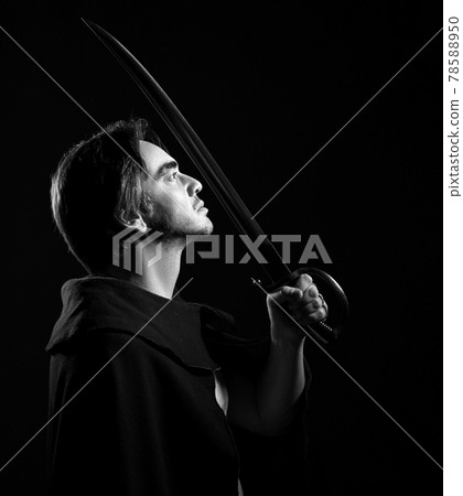 Black and white portrait of adult man in cape 78588950