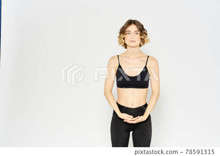 Woman in sportswear on a light background exercise fitness sport balance model Woman in sportswear on a light background exercise fitness sport balance model 78591315