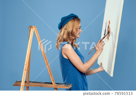 Woman artist tail hand brush drawing art Creative lifestyle blue background 78591513