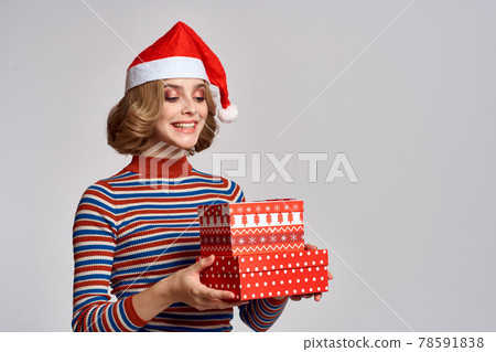happy woman with christmas gifts in hands and red hat on head new year holidays cropped view happy woman with christmas gifts in hands and red hat on head new year holidays cropped view 78591838