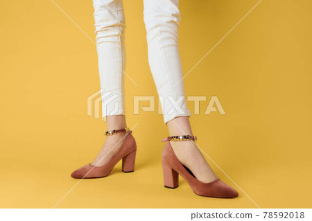 Female legs white pants fashionable clothes shoes luxury yellow background 78592018