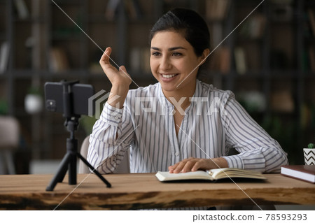 Happy indian female vlogger having video live stream on smartphone Happy indian female vlogger having video live stream on smartphone 78593293