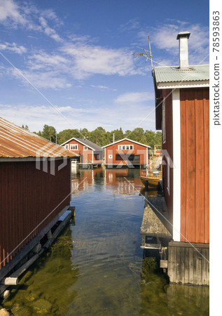 Swedish harbour with traditional red painted houses 78593863