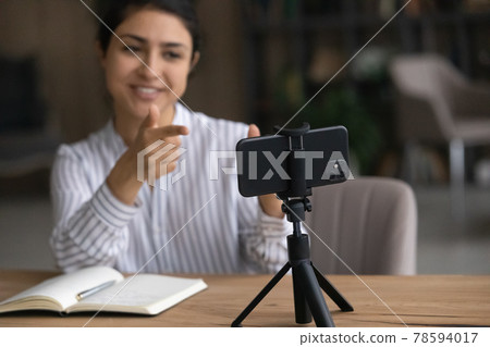 Active young indian female shoot motivational training on cell webcam 78594017