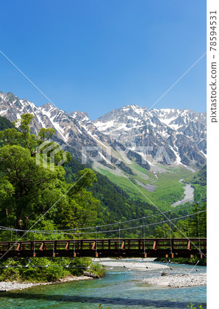 Hotaka mountain range with residual snow from the fresh green Kappa Bridge Hotaka mountain range with residual snow from the fresh green Kappa Bridge 78594531