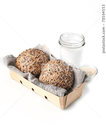 buns with sesame seeds side view in wooden basket on white background isolated closeup. Selective focus 78594553