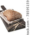 loaf of bread side view on wooden board on white background  isolated closeup. Selective focus 78595159