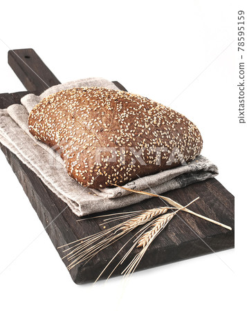 loaf of bread side view on wooden board on white background  isolated closeup. Selective focus 78595159