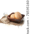 fresh wheat buns with sesame seeds in brown wooden plate side view on white background isolated closeup. Selective focus 78595160