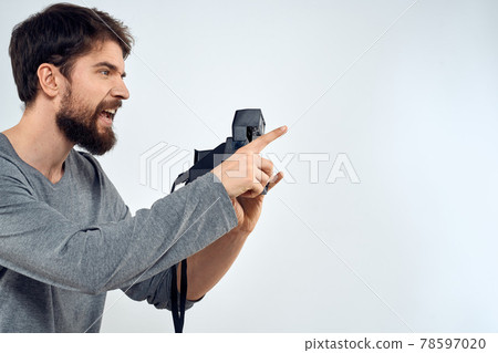 photographer with camera hobby technology studio lifestyle creative light background 78597020