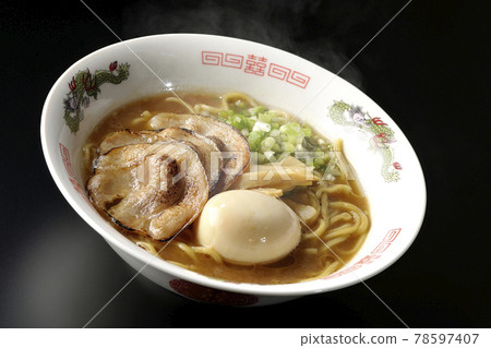 Photographed hot pork bone soy sauce ramen with roasted char siu, taste balls, menma and all-purpose green onions on a black background Photographed hot pork bone soy sauce ramen with roasted char siu, taste balls, menma and all-purpose green onions on a black background 78597407