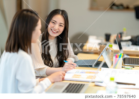 Business scene of two women having a meeting while looking at the floor plan of the house 78597640