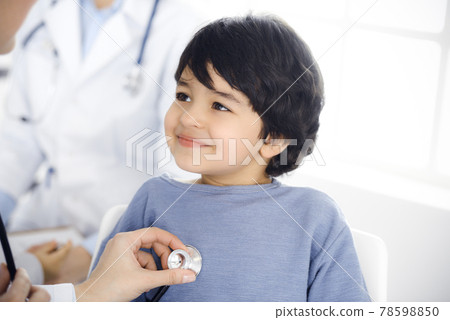 Doctor-woman examining a child patient by stethoscope. Cute arab boy at physician appointment. Medicine concept 78598850