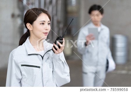 Two workers checking the site with a transceiver in one hand 78599058