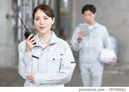 Two workers checking the site with a transceiver in one hand Two workers checking the site with a transceiver in one hand 78599062