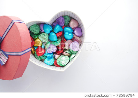small heart shape gift with candy on white background  78599794