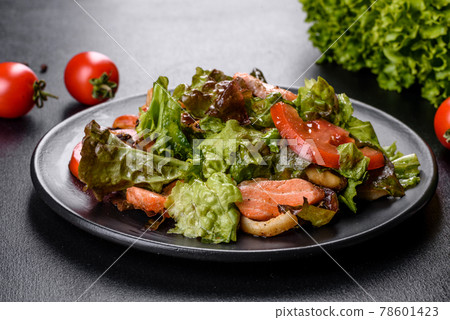 Delicious fresh salad with fish, cheese, tomatoes and lettuce leaves Delicious fresh salad with fish, cheese, tomatoes and lettuce leaves 78601423
