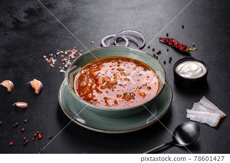 Delicious fresh hot borsch with tomato and meat in a ceramic plate 78601427