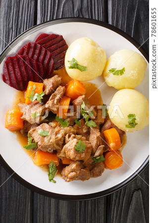 Kalops is a traditional Swedish beef stew that is slowly cooked with vegetables and spices close up in the plate. Vertical top view 78601655