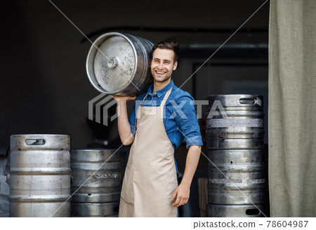 Attractive confident strong man working at plant. Owner of brewery, employee at storage 78604987