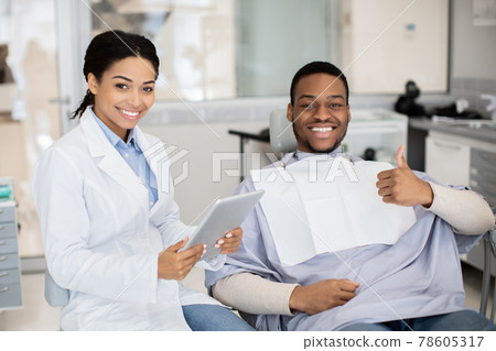 Happy Black Man Showing Thumb Up After Dental Treatment In Stomatologic Clinic 78605317