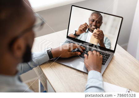 Young man watching online DIY class, participating in woodworking workshop, using laptop at home Young man watching online DIY class, participating in woodworking workshop, using laptop at home 78605328