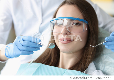 Portrait of beautiful woman at dentist appointment 78606368