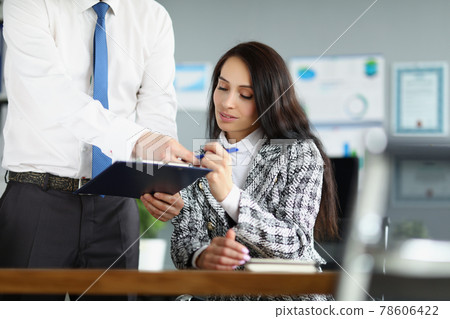 Woman CEO signs business contract that is opposed by her employee 78606422