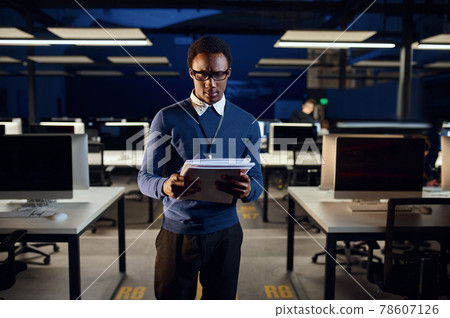 Manager looks in notebook, night office lifestyle 78607126