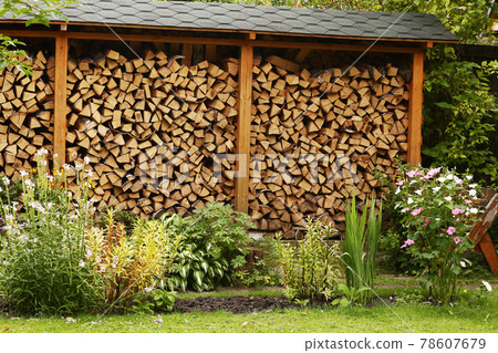 beautiful formal garden with flowers and fire wood storage beautiful formal garden with flowers and fire wood storage 78607679