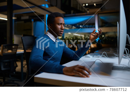 Man in glasses works on computer, office lifestyle Man in glasses works on computer, office lifestyle 78607712