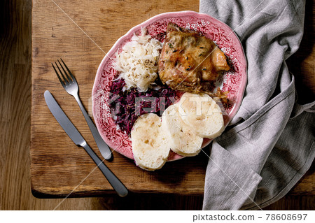 Baked duck legs with sliced boiled knedliks and sauerkraut Baked duck legs with sliced boiled knedliks and sauerkraut 78608697