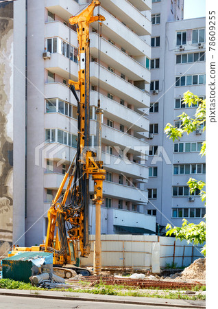 Drilling rig for driving concrete piles at a construction site. Drilling rig for driving concrete piles at a construction site. 78609255