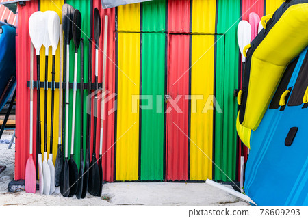 Colorful water sport storage with paddles in the front door. Colorful water sport storage with paddles in the front door. 78609293