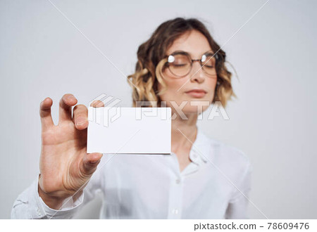 Business woman in shirt with business card in hand mockup Business woman in shirt with business card in hand mockup 78609476