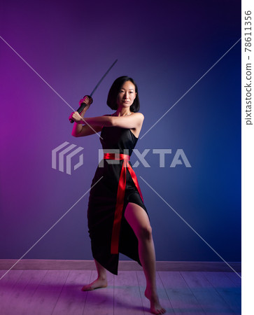 slender Asian woman in a black dress with a katana in her hand image of a samurai on a neon background slender Asian woman in a black dress with a katana in her hand image of a samurai on a neon background 78611356