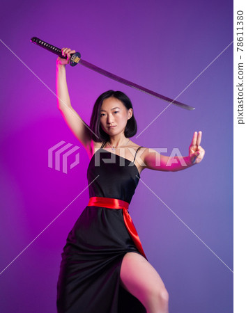 slender Asian woman in a black dress with a katana in her hand image of a samurai on a neon background slender Asian woman in a black dress with a katana in her hand image of a samurai on a neon background 78611380