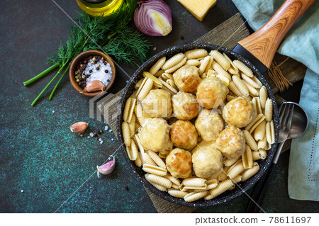 Italian pasta. Spaghetti with meatballs in cheese sauce on a dark stone or concrete background. Top view, flat lay background. Copy space. Italian pasta. Spaghetti with meatballs in cheese sauce on a dark stone or concrete background. Top view, flat lay background. Copy space. 78611697