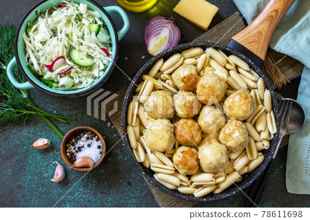 Italian pasta. Spaghetti with meatballs in cheese sauce on a dark stone or concrete background. Top view, flat lay background. Copy space. Italian pasta. Spaghetti with meatballs in cheese sauce on a dark stone or concrete background. Top view, flat lay background. Copy space. 78611698