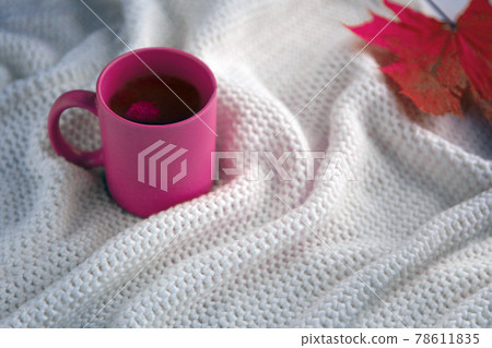pink tea cup with white scarf background, ceramic cup with autumn leaf, white blanket with hot drink pink tea cup with white scarf background, ceramic cup with autumn leaf, white blanket with hot drink 78611835